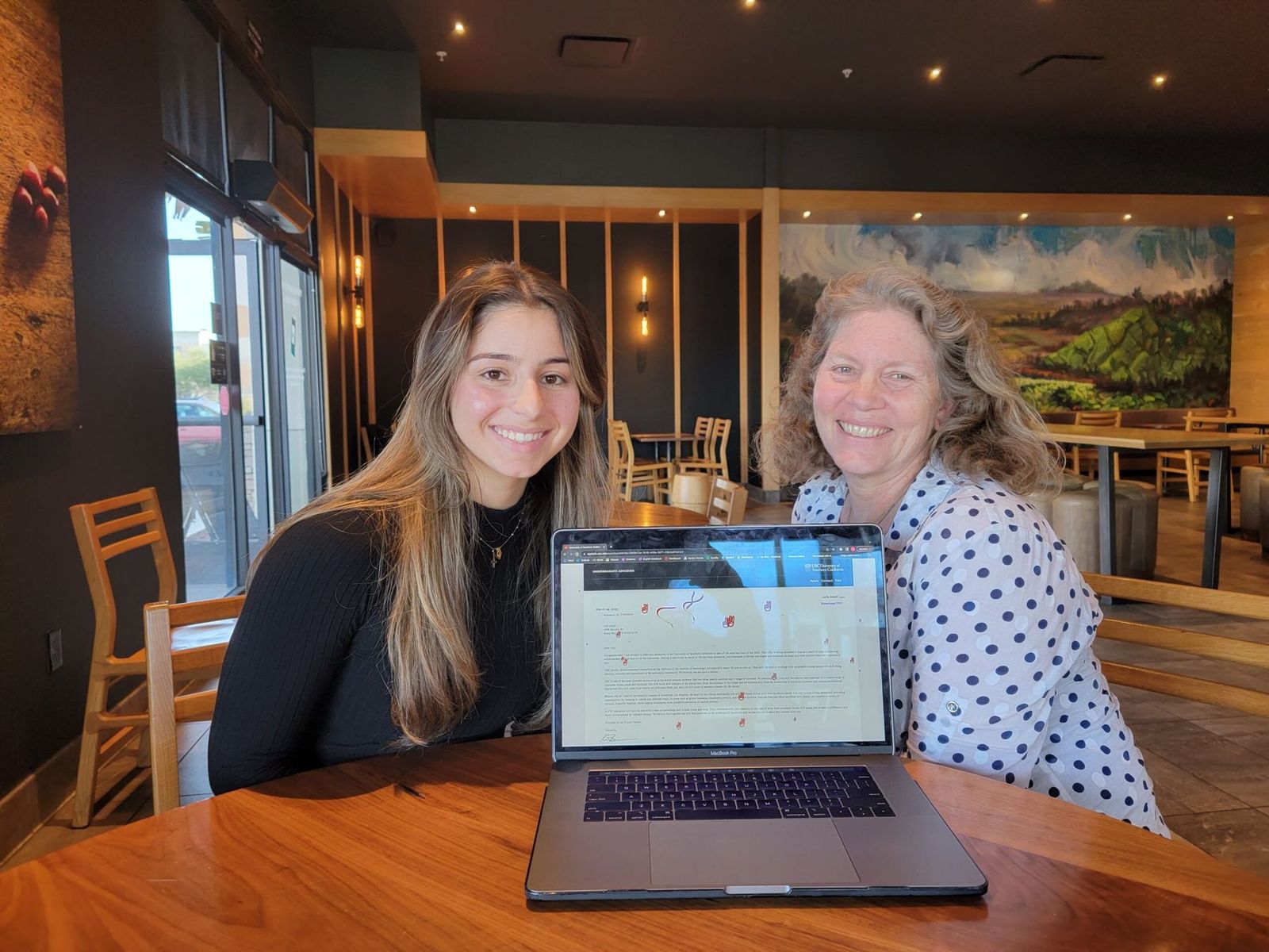 Julie and Lynda Cummings at a laptop the day Julie heard from USC